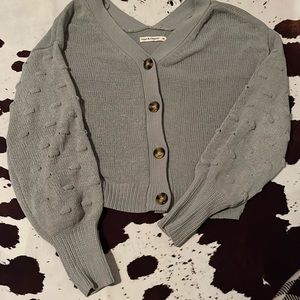 it is a sage green sweater.